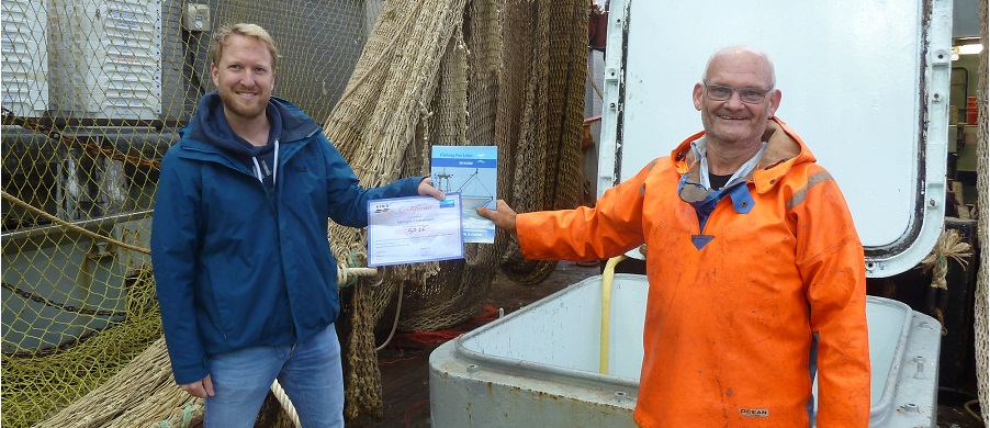 KIMO Netherlands and Belgium Chair Sebastian Dinjens presents the first Fishing for Litter certificate to Dutch fisherman Gert Lokker.