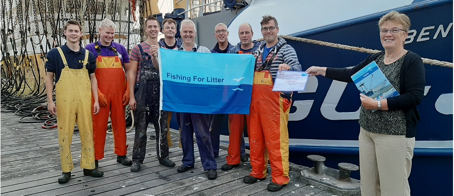 Tea Both, Alderman of Goeree Overflakkee and Vice-Chair of KIMO Netherlands and Belgium presents a Fishing for Litter certificate to a crew of Dutch fishermen.