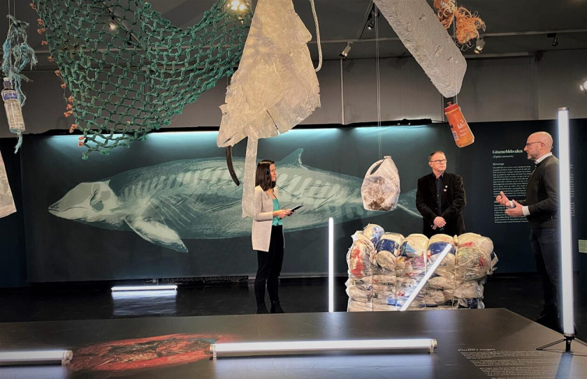 The moderator conducting an interview about the plastic whale.